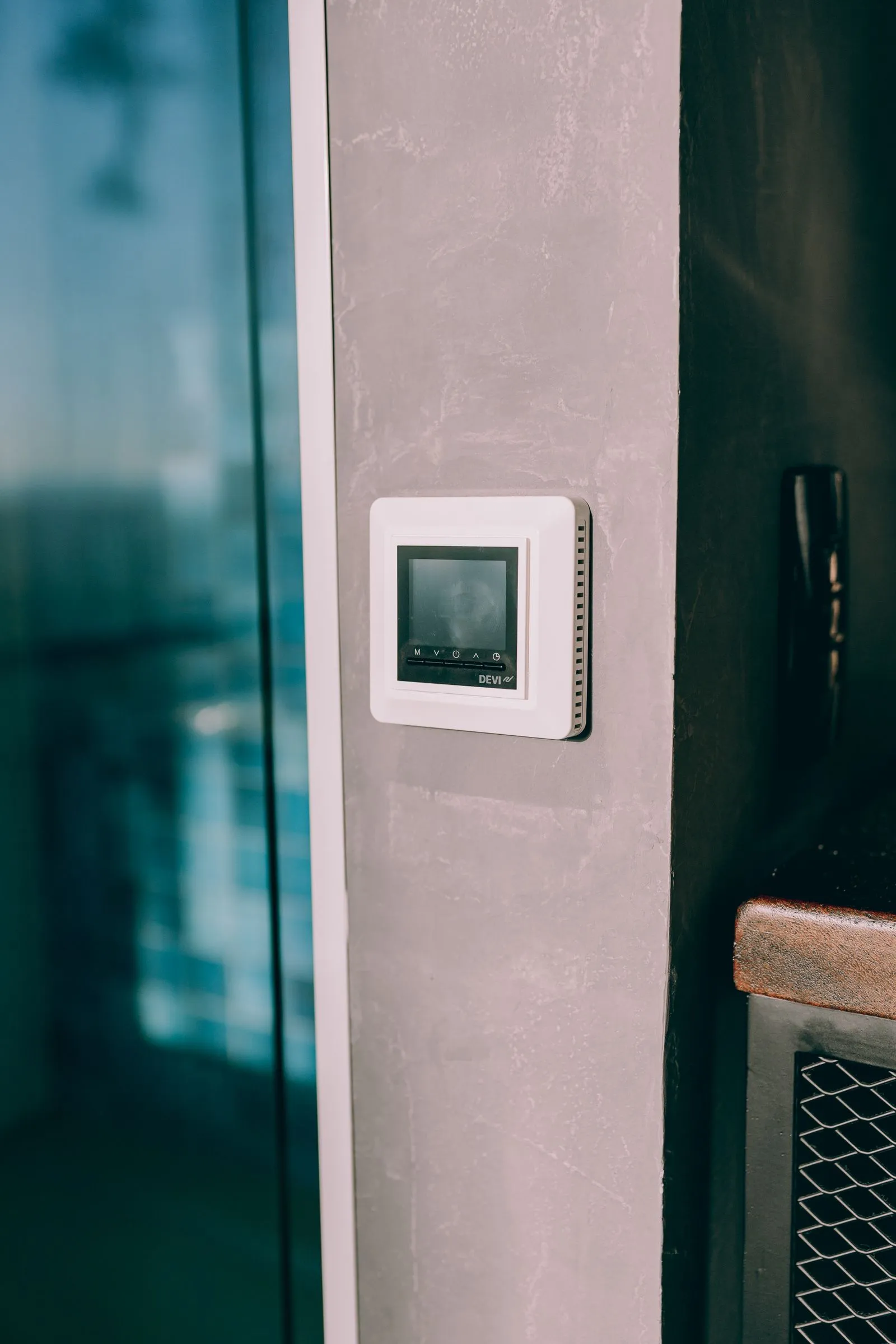 A wall-mounted thermostat in a Cambridge home — how the heat pump is controlled shapes how quickly it pays for itself.